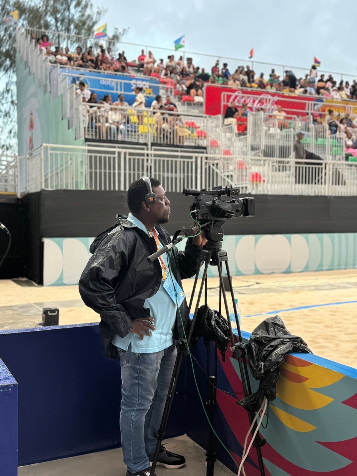 Allen operating a broadcast camera at a sporting event