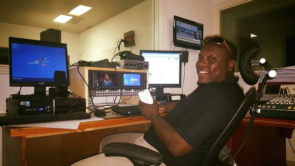 Allen in a production control room with monitors and an audio console