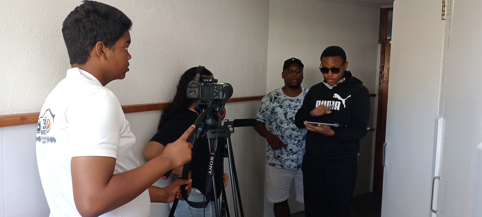 Workshop participants operating a camera and clapperboard