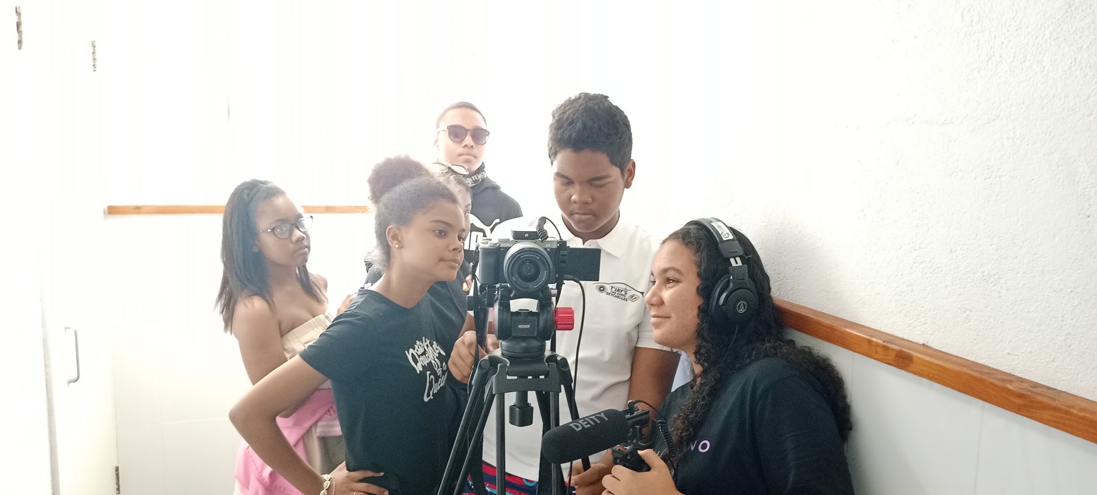 Young filmmakers working together around a camera and microphone