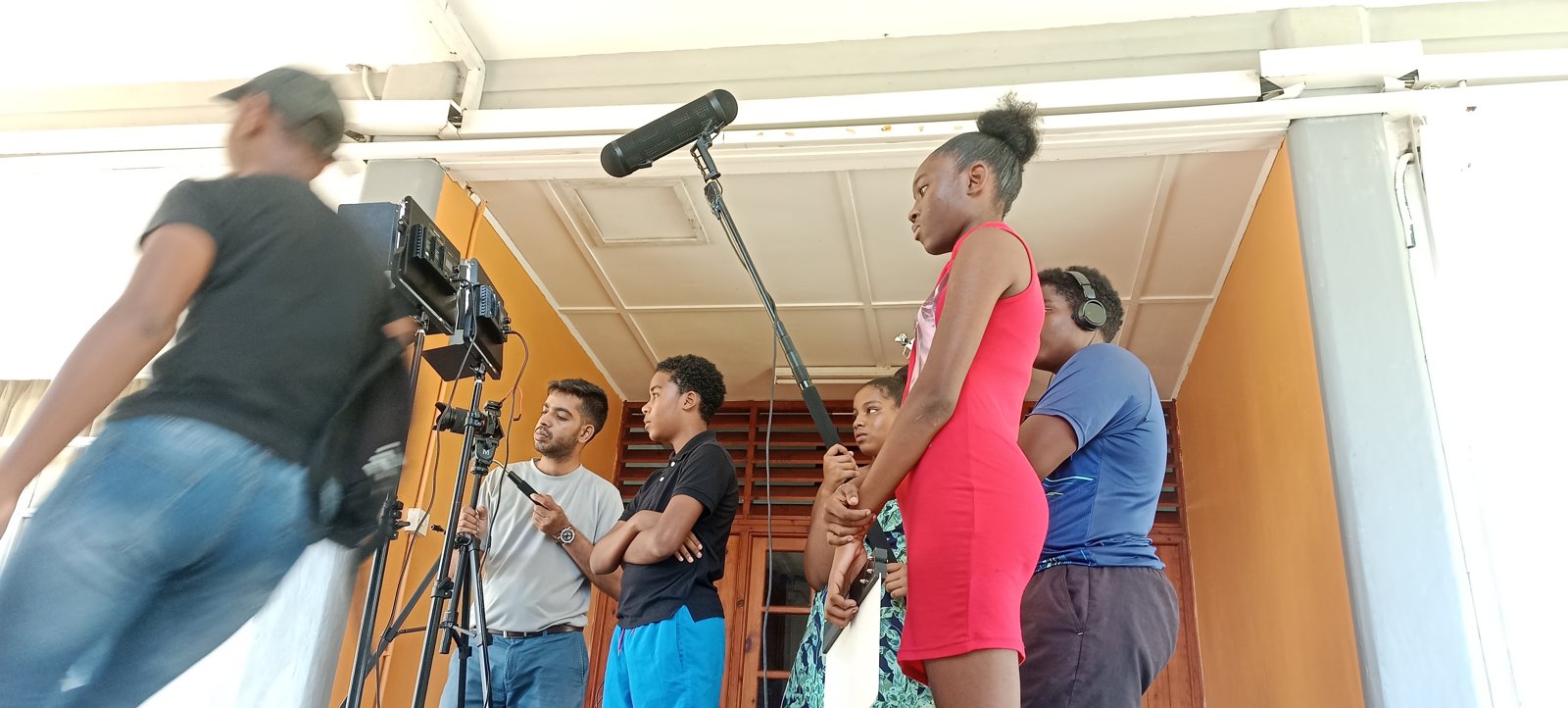 Youth filmmaking workshop with a camera and boom microphone